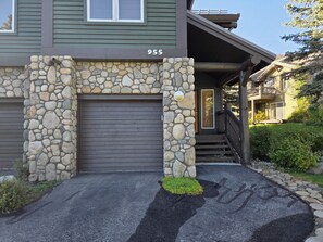 A house with a stone facade, a garage door, and a number '955' on the wall. - Snowcreek Resort Vacation Rental 955 (Mammoth Lakes)