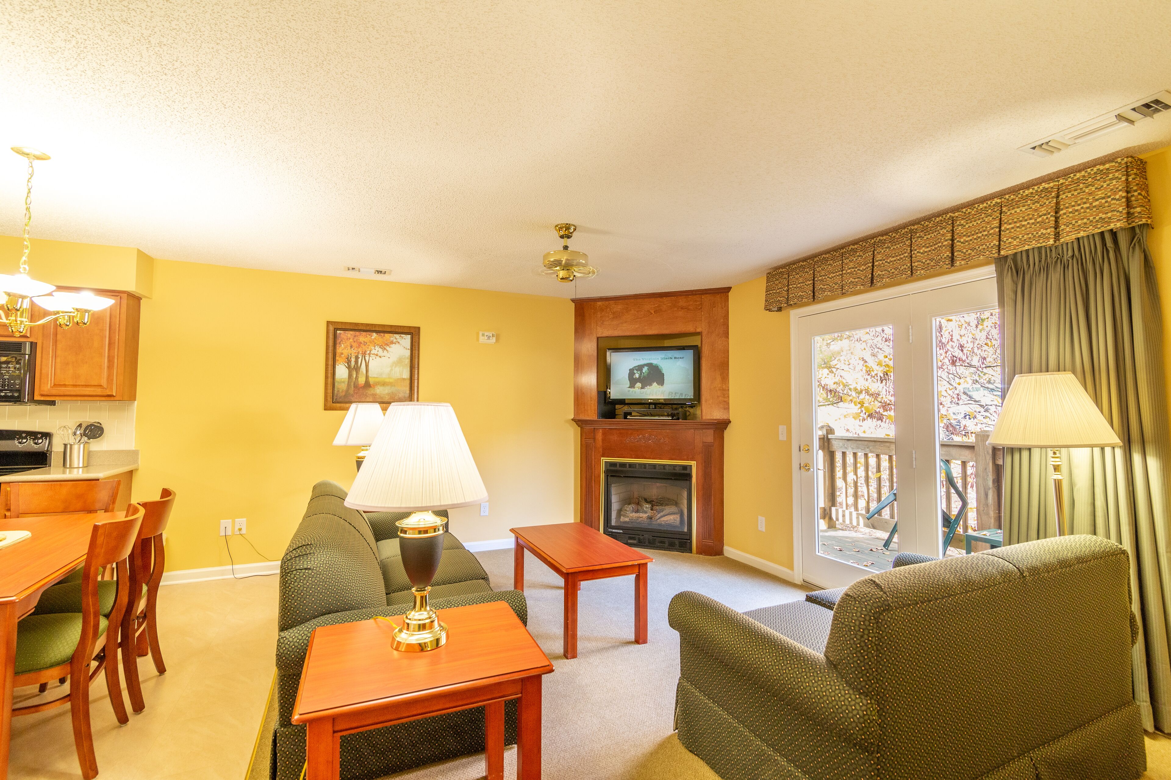 A living room with a fireplace, television, and seating area.