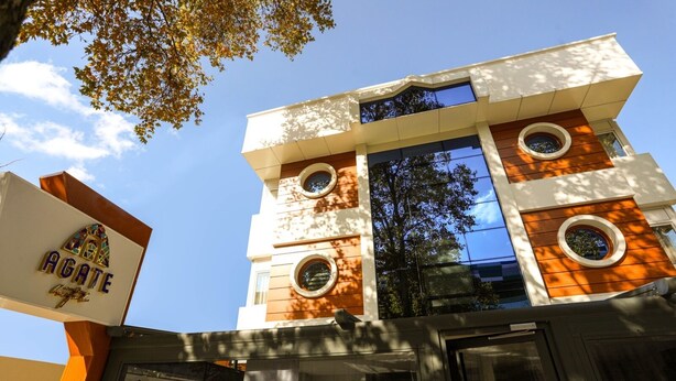 A modern building with a prominent sign reading "AGATE."