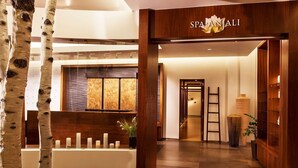 A spa entrance with a wooden reception desk, a large vase, and a sign reading "SPA ANJALI". - Riverfront Resort and Spa - Luxury Studio Suite: SKI IN / SKI OUT (Avon)