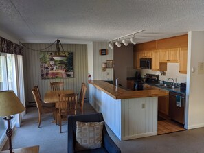 A compact kitchen with wooden cabinets, a microwave, and a sink. - 2BR 2BA Condo short walking distance to Vail Mountain gondola, Lionshead Village (Vail)