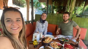 A dining table with food, drinks, and a bottle of wine. - Dalaman Airport Guesthouse (Dalaman)
