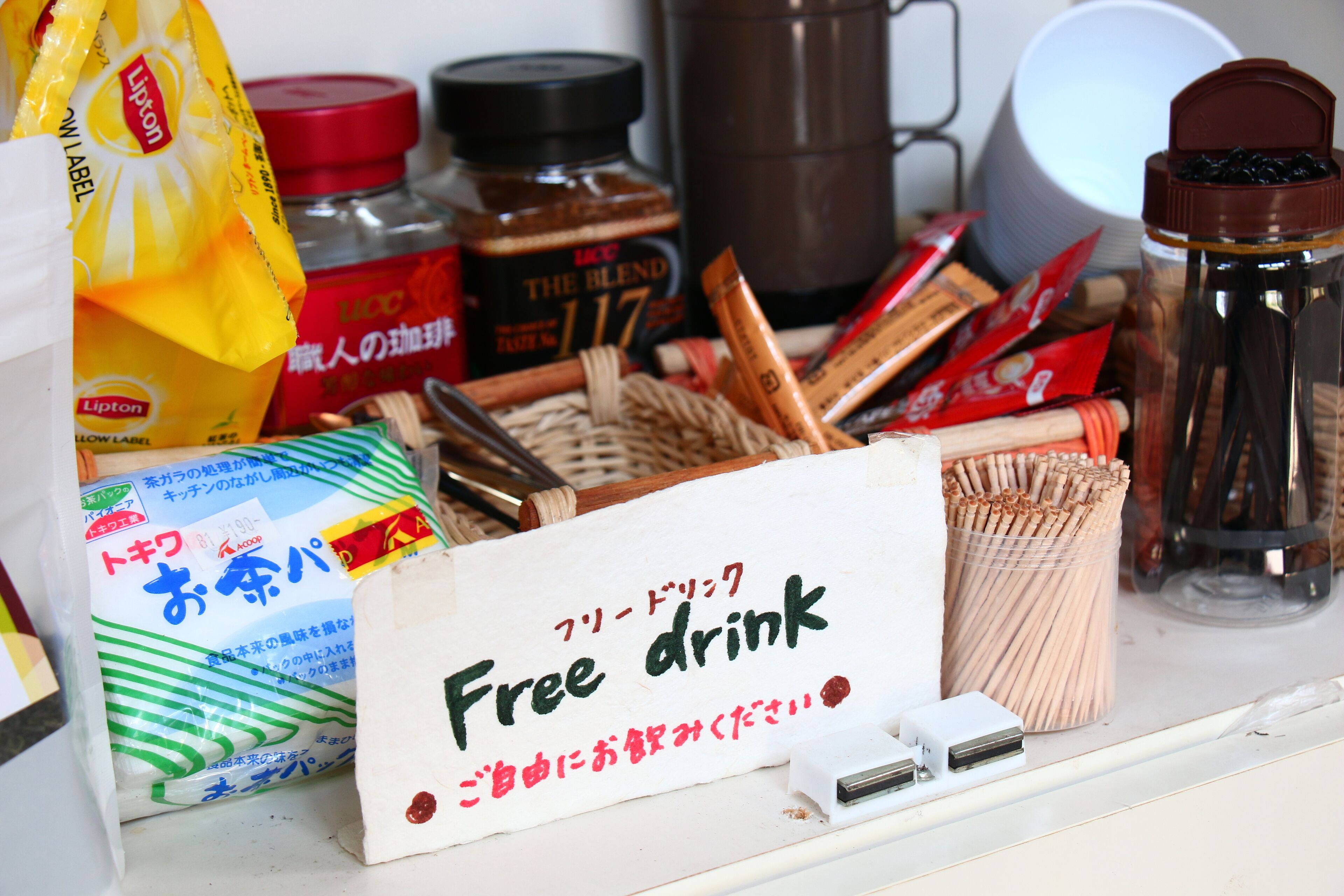 A table with various food items and a sign that says "Free drink".