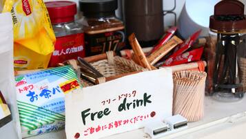 A table with various food items and a sign that says "Free drink".