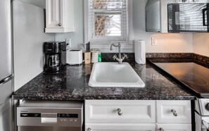 Enjoy cooking in this fully equipped kitchen with a dishwasher, refrigerator, and microwave.