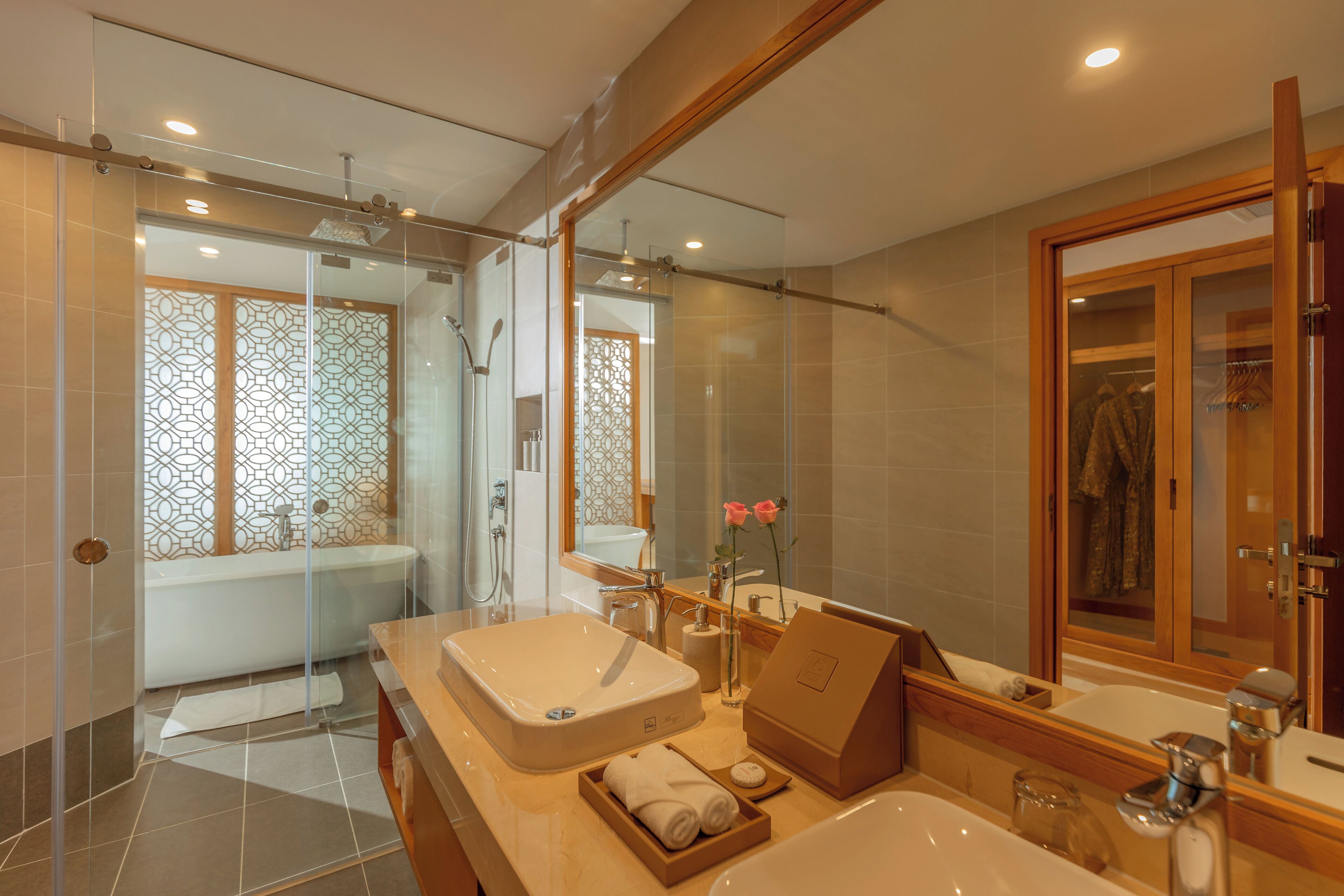 A modern bathroom with a large sink, a bathtub, and a shower area.