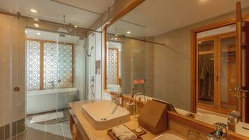 A modern bathroom with a large sink, a bathtub, and a shower area.