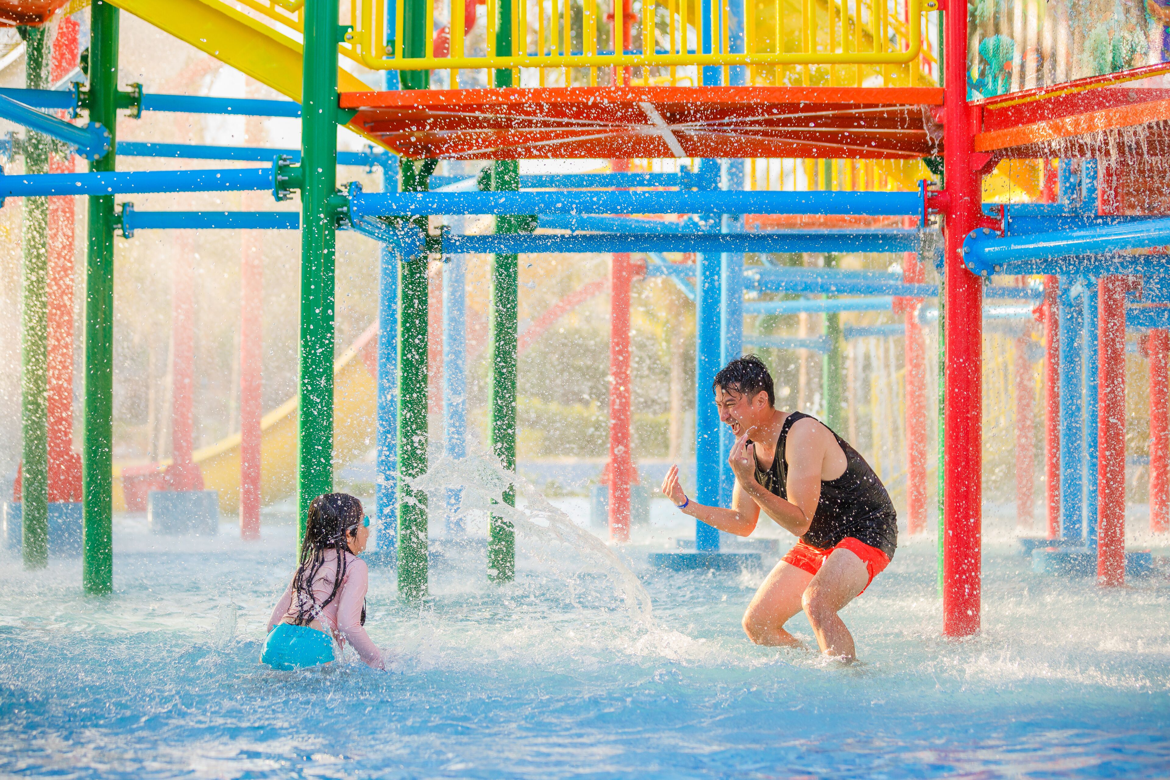 A water play area with colorful structures and water jets.