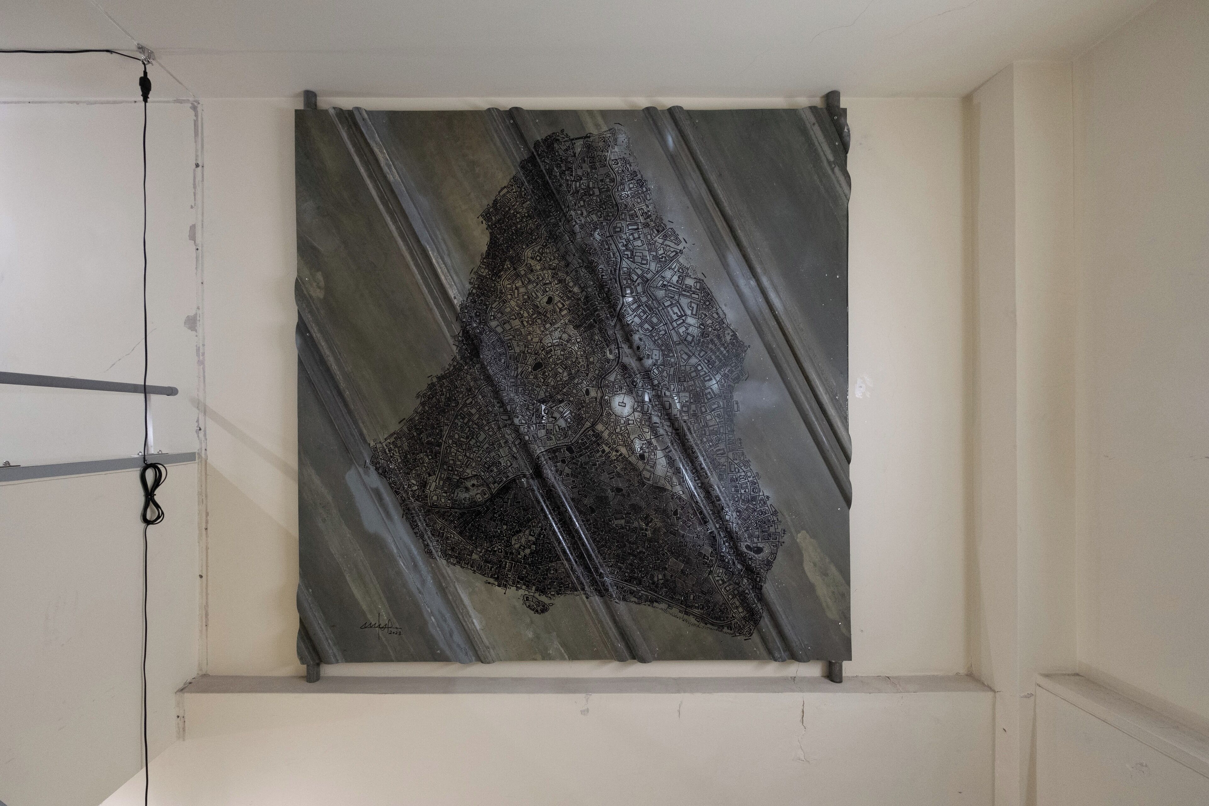 A room with a large, dark, abstract artwork on the wall.