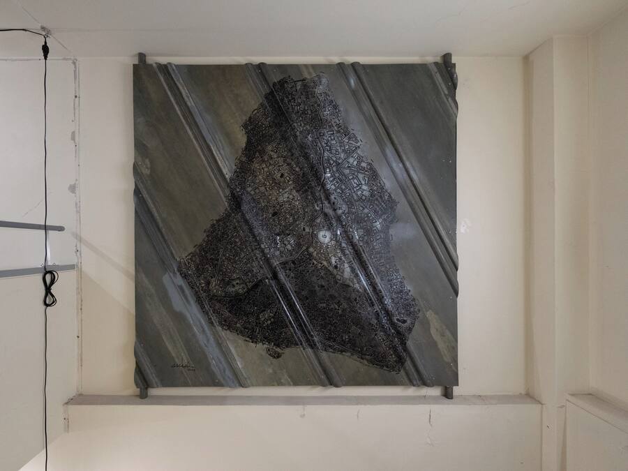 A room with a large, dark, abstract artwork on the wall.