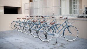 A row of bicycles parked against a building facade.