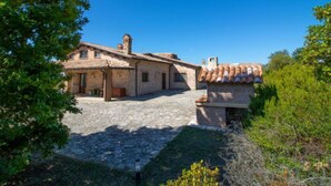 A stone building with a tiled roof, a chimney, and a small bell tower. - La Danza by Interhome (Todi)
