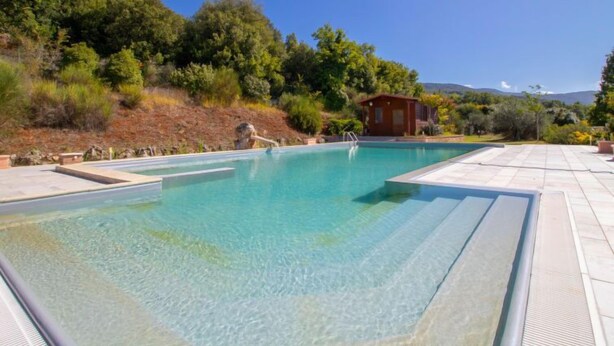A rectangular swimming pool with clear water, surrounded by a tiled deck. - La Danza by Interhome (Todi)