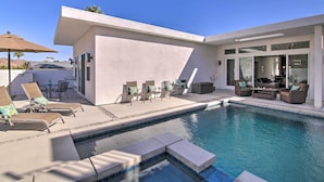 A modern outdoor pool area with lounge chairs and a patio table. - 068332: 'Desert Pearl' 3 BR Oasis w/ Private Pool! (La Quinta)