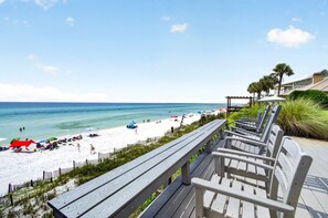 A beach with a wooden walkway and beach chairs. - The Point - Oceanfront Home in Blue Mountain Beach with Direct Beach Access (Santa Rosa Beach)