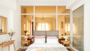 A bedroom with a large bed, a desk, and a chair. - A short walk to Syntagma and Plaka (Athens)