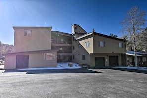 A multi-story building with a garage, a small attached structure, and a balcony. - Angel Fire Mtn Escape: Walk to Chile Express Lift! (Angel Fire)