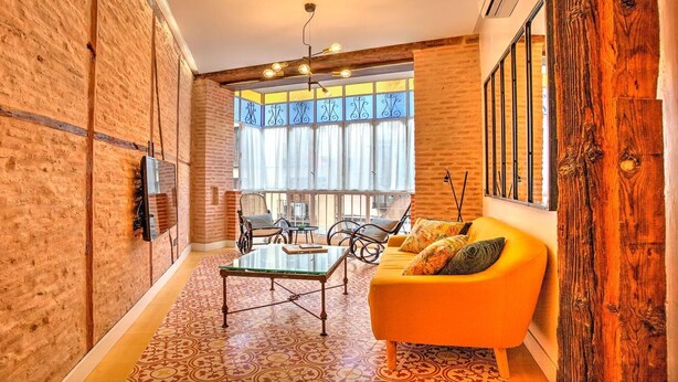 A modern living room with a glass coffee table, a sofa, and a dining table. - DELUX APARTMENT CASA DEL ANILLO TOLEDO (Toledo)