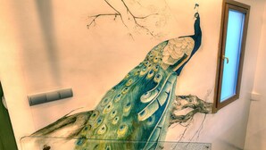 A peacock mural on a wall with a window to the right. - SYNAGOGUE 6 DELUXE WITH PRIVATE TERRACE (Toledo)
