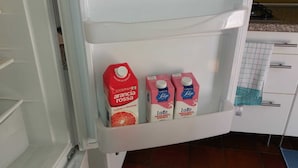 A refrigerator shelf with three cartons of milk. - Nice Apartment Venice (Mestre)