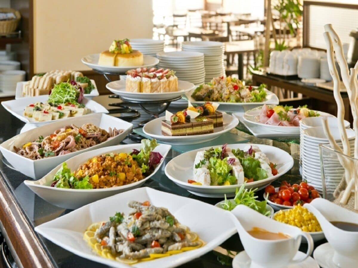 A buffet with various dishes and a coffee cup.