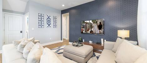 Flat-screen TV, fireplace, video game console, ping pong