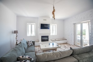 Deluxe Villa | Living room | LCD TV, fireplace, toys - Fabulous pool villa near the beach by VillaRentalsgr (Paros)