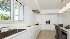 Villa, 3 Bedrooms (Villetta Cala Sassari) | Private kitchen | Full-size fridge, oven, stovetop, dishwasher - Cala Sassari (Golfo Aranci)