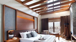 A modern bedroom with a wooden ceiling, a large bed, a desk, and a view of the outdoors. - Magna Pivot Hotel - Boutique Class (Kayseri)