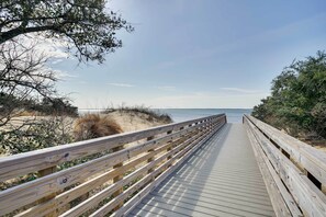 A wooden boardwalk leading to a beach with sandy dunes and sparse vegetation. - Nags Head Fall Escape Near Dunes & Fishing (Nags Head)