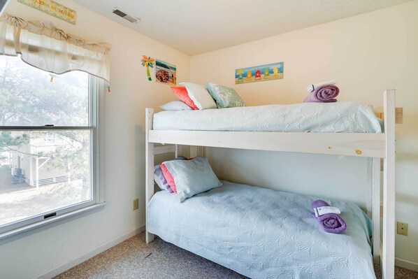 A bunk bed room with a window, two pillows, and a towel on the lower bunk. - Nags Head Fall Escape Near Dunes & Fishing (Nags Head)