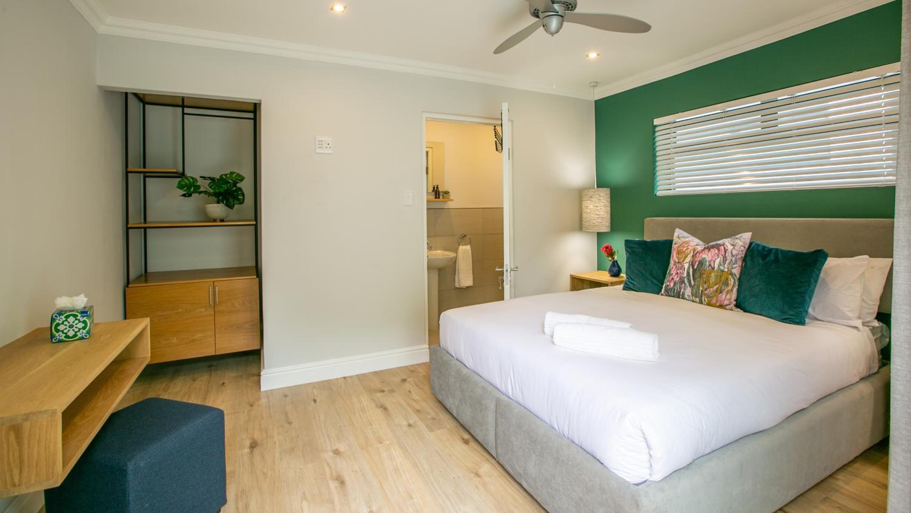 A bedroom with a bed, bedside table, and a built-in wardrobe.