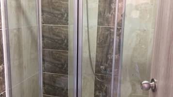 Shower, hair dryer, slippers, towels