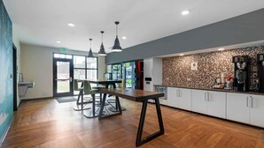 A modern kitchen with wooden flooring, pendant lighting, and a coffee station. - Extended Stay America Premier Suites Bluffton Hilton Head (Bluffton)