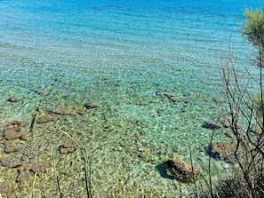 A clear view of a beach with visible rocks and sparse vegetation. - Nice apartment for 4 people with pool, A/C, WIFI, TV and panoramic view (Otranto)