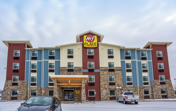 Un hotel de varios pisos con un llamativo letrero de 'My Place Hotels'.