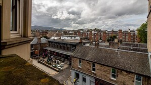 A traditional British town with terraced houses and a pub named 'The Merlin'. - Beautiful and Bright Georgian Style Morningside Apartment - Pass the Keys (Edinburgh)
