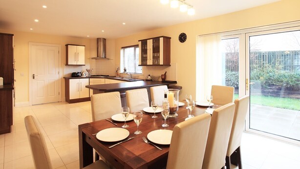 A modern kitchen with a dining area. - Ardmullen 4 bed Walnut (Kenmare)