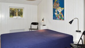 A room with a large bed, a chair, a desk with a lamp, and a painting on the wall. - Awesome home in Strandby with kitchen (Strandby)