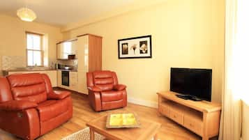 Apartament Deluxe | Sala d'estar | Televisor de pantalla plana