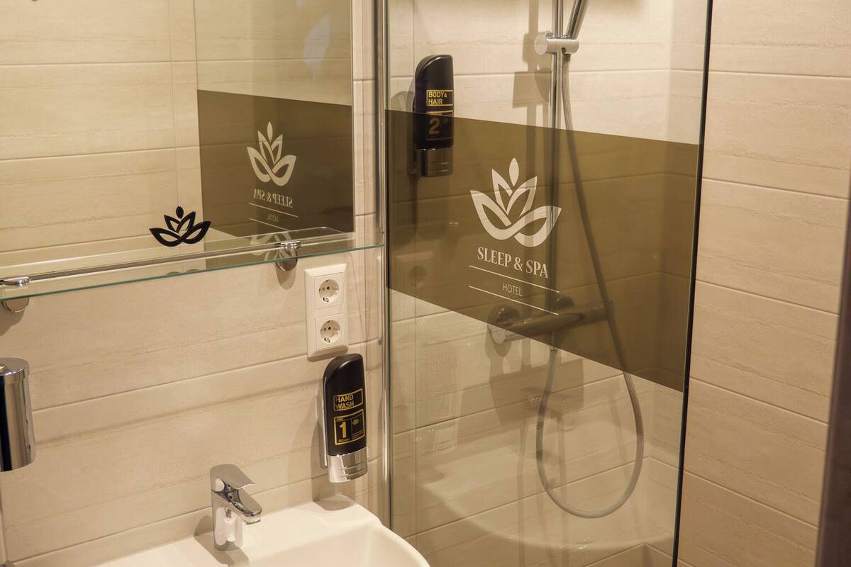 shower, hair dryer, towels, toilet paper