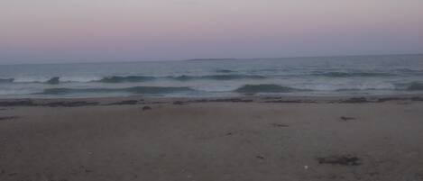 A beach with a clear sky and calm sea.