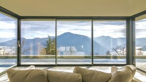 A room with a large window offering a mountain view. - VILLA PRESTIGE - Eight Bedroom Villa, Sleeps 14 (Pigra)