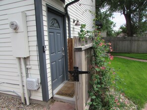 Stylish home with a simple, functional design, featuring a cozy porch and a well-manicured lawn.