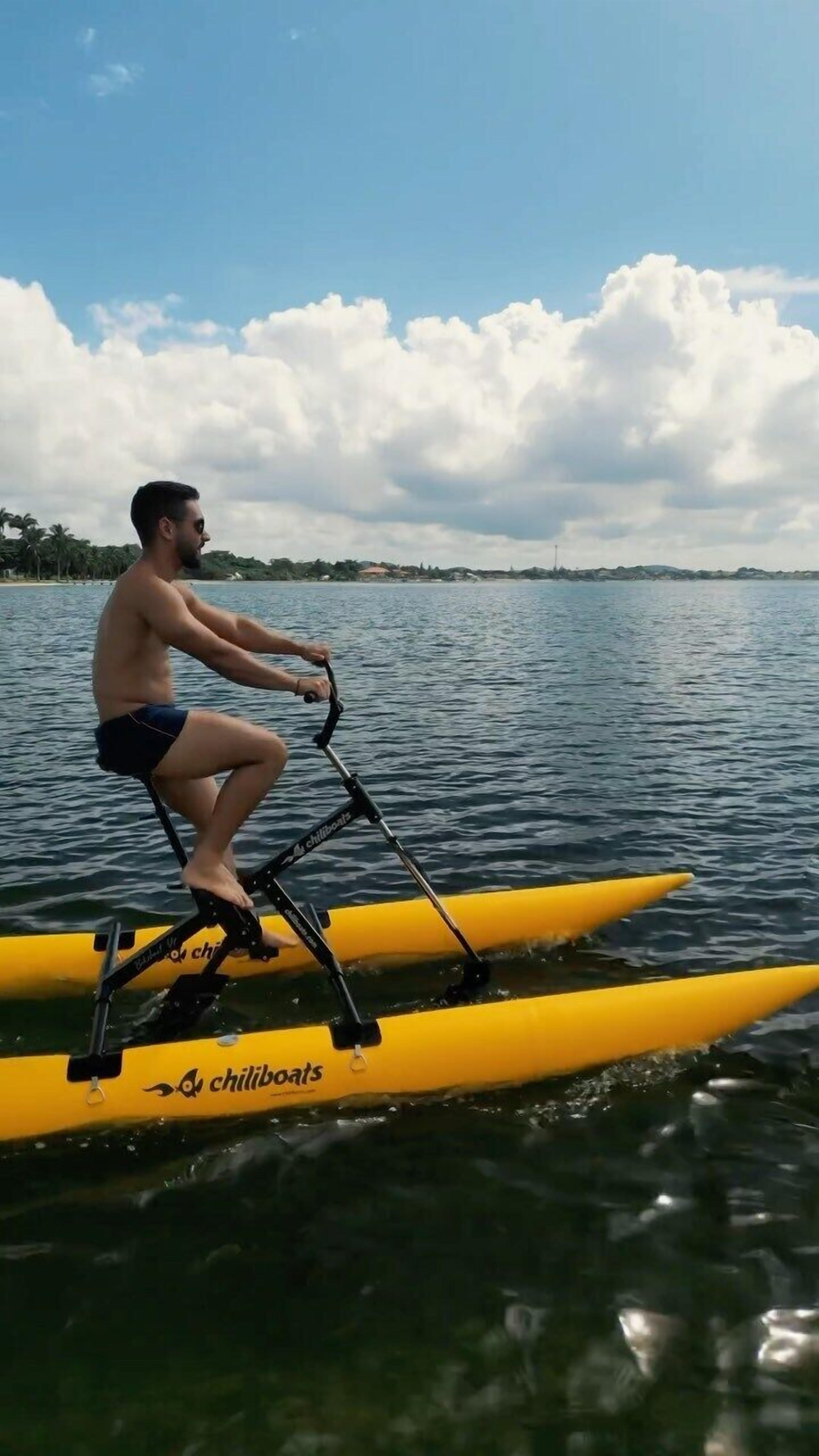 A person riding a yellow inflatable boat on water.