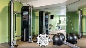 A gym with exercise equipment, a mirror, and exercise balls. - WoodSpring Suites Indianapolis Castleton (Indianapolis)