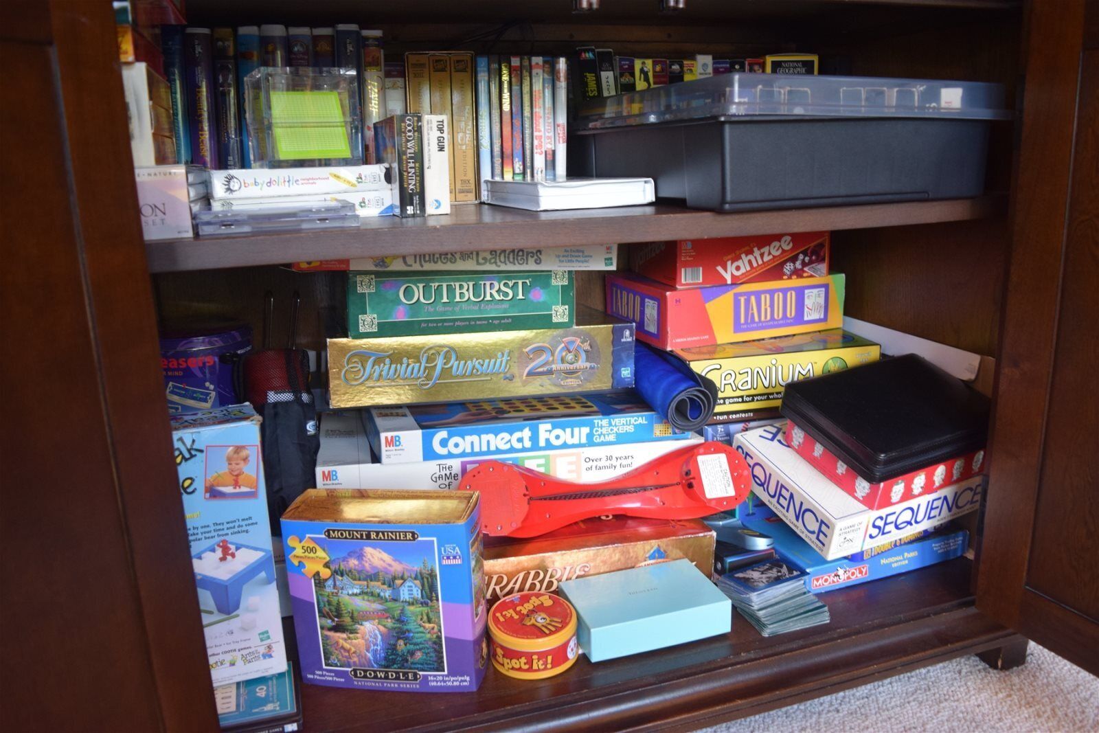 A bookshelf filled with various board games and books.