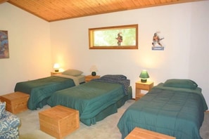 A room with two beds, wooden headboards, and a wooden ceiling. - Trails End (Packwood)