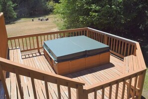 A wooden deck with a green table and benches. - Trails End (Packwood)