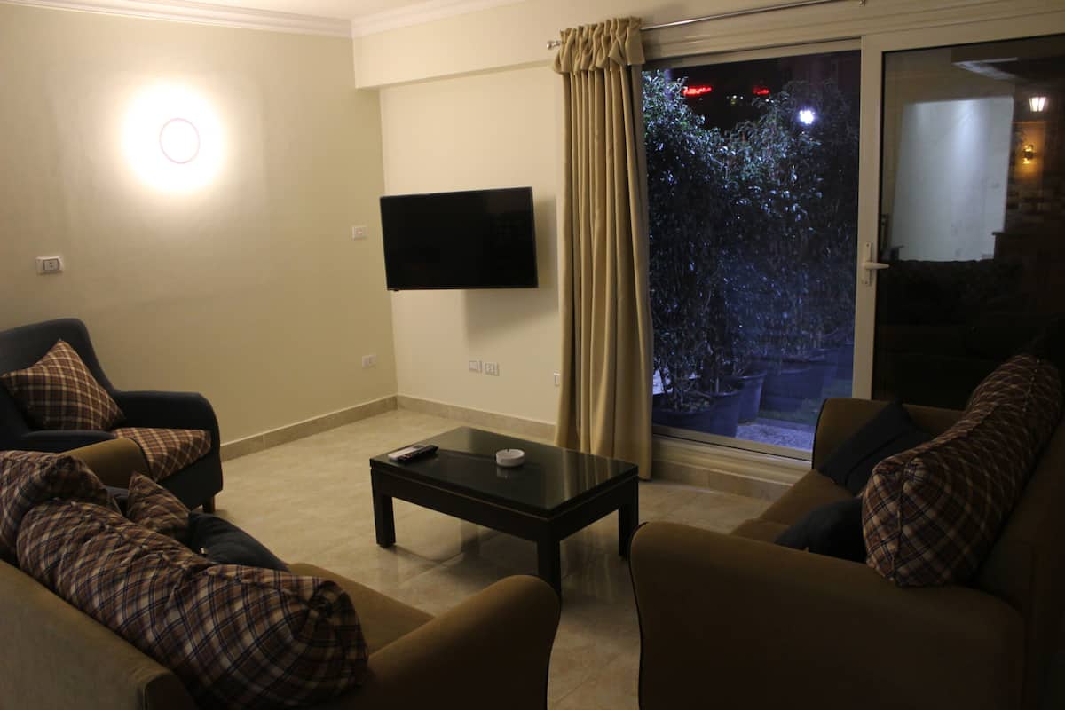 Superior Apartment (Ground Floor) | Living area | 52-inch Smart TV with satellite channels, TV